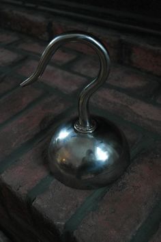 a metal object sitting on top of a brick floor