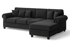 a black couch with lots of pillows on the top and bottom end, sitting in front of a white background