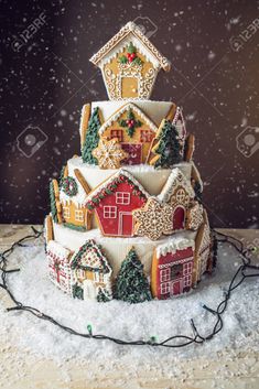 a decorated christmas cake on a table with snow falling around it stock photo - 9579