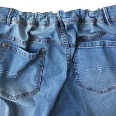 a pair of blue jeans with white stitching on the back and side pockets, sitting against a white background