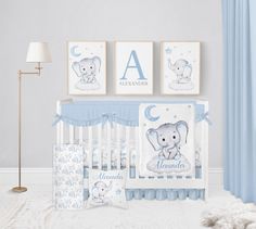 a baby's room with blue and white decor, including a crib bedding set