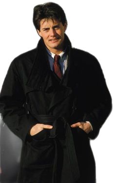 a man wearing a trench coat and tie