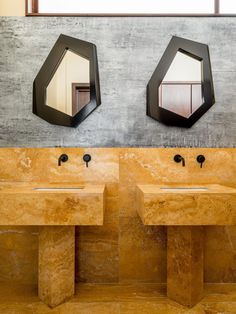 two sinks in a bathroom with mirrors above them