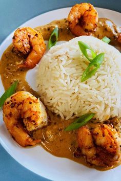 a white plate topped with rice and shrimp