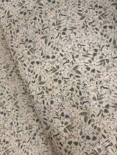 an image of a white and black floral pattern on a fabric with small flowers in the center