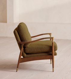 a green chair sitting on top of a hard wood floor