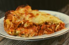 a slice of lasagna sitting on top of a white plate