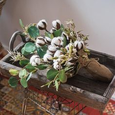 cotton flowers in a basket on a table