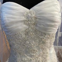 a white wedding dress with beaded details on the boudon and neckline