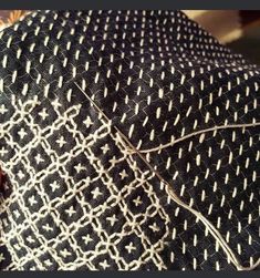 a close up view of a black and white patterned fabric with an intricate design on it