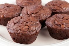 several chocolate muffins on a white plate