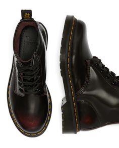 The iconic 1460 Dr. Martens boot features 8 eyes, grooved sides, a heel-loop, yellow stitching, and an air-cushioned sole. Made with Arcadia leather that develops a two-tone effect with wear, these boots also have our signature oil and fat resistant AirWair™ Bouncing Soles for traction and durability. To maintain the unique 2 tone look, simply clean with a damp cloth and use a Dr.Martens clear or colored wax polish. Available in true US sizes with room for comfort or thicker socks. UK sizes disp Rag Clothes, 1460 Dr Martens, Cherry Red Dr Martens, Red Dr Martens, Boots Uk, Leather Lace Up Boots, Thick Socks, Doc Marten Oxford, Fashion 2024