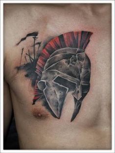 a man with a spartan helmet tattoo on his chest