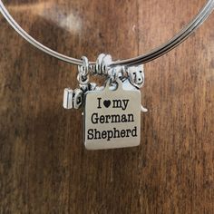 a charm that says i love my german shepherd on it