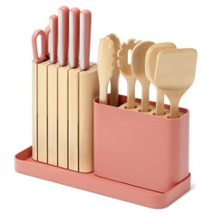 a set of utensils in a pink holder