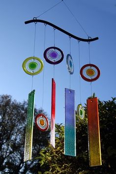 colorful wind chimes hanging from a tree branch