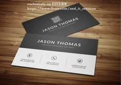 two black and white business cards sitting on top of a wooden table