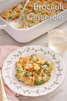 broccoli casserole on a plate next to a glass of water