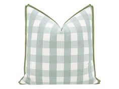 a green and white checkered pillow on a white background