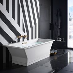 a black and white bathroom with a large window