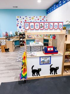 a child's playroom with toys and bookshelves, including a toy store counter