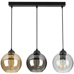 three glass globe pendant lights hanging from a black metal bar over a white background with the light bulb turned on