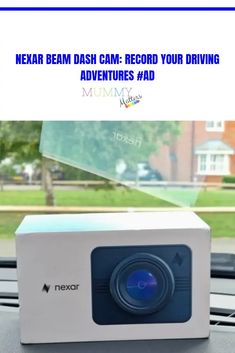 an image of a projector sitting on top of a table in front of a window with the words nexar beam dash cam - record your driving adventures