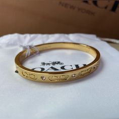 Nwt! Beautiful Authentic Coach Hinge Bangle Bracelet In Yellow Gold, With Delicate Rhinestones And “C” Logos. Very Elegant. An Accessory That Goes Well With Any Outfit. Brand New, Tags Attached. Opens Up For Easy On And Off. Comes With Coach Branded Retail Store Gift Box And Coach Branded/Logo Tissue Paper. Ready To Gift! - Hinge Closure - Insert Buckle Design Designer Plaque - Adjustable Push-Stud Fastening - 2.25” Diameter And 2” Width Approximately This Listing Includes: - New Coach Bracelet With Tags - White Jewelry Pouch/Coach Drawstring Bag - Coach Gift Box - Coach Branded Tissue Paper, Logos New To Poshmark? Sign Up Now With My Code Mmrt330 To Save $10 On Your Fir Coach Christmas, Coach Yellow Gold Jewelry For Formal Events, Elegant Coach Jewelry For Anniversary, Elegant Coach Bracelets As Gift, Coach Bracelet Jewelry Gift, Coach Formal Bracelet Jewelry, Gold Coach Jewelry For Anniversary, Coach Gold Jewelry For Anniversary, Elegant Coach Bracelets For Gift