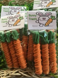 some carrots are wrapped in plastic and have bunny treats on them for kids to eat