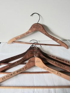 four wooden hangers with names on them