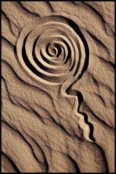 an image of a spiral in the sand