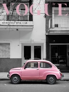 an old pink car parked in front of a building with the word voquet on it