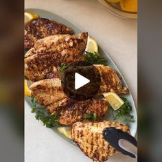 grilled chicken with lemons and parsley on a plate