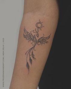 a woman's arm with a tattoo design on the left side of her arm