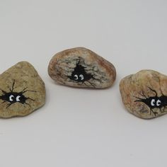 three rocks with faces painted on them, one has eyes and the other has noses