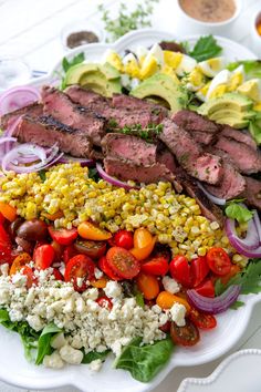 a white plate topped with meat and veggies