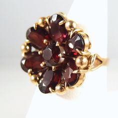 "IMPORTANT: A description is available following the details. Please, read on. Thank you. Material: 18 K solid gold, 6 oval-shaped faceted garnets measuring approximately 8mmx6mm; one round cut faceted garnet measuring approximately 6mm. Total 9.4cttw Size: 7 1/4 The face of the ring measures approximately a large 2.2mm (round) weight: 8.2g Period: 1900s, late Victorian, early Art Nouveau Provenance: an estate sale in Paris, France Condition: excellent estate, minor wear Additional remarks: stam Fine Gold Jewelry, French Luxury, Vintage Jewelry Art, Jewelry Brands, Gem Show, Italian Jewelry, Garnet Jewelry, Victorian Jewelry, Flower Ring