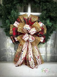 a christmas wreath on a window sill in front of a door with the word love written on it