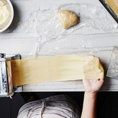 a person is making dough on a table