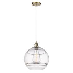 a clear glass globe light hanging from a ceiling fixture with an antique brass metal finish