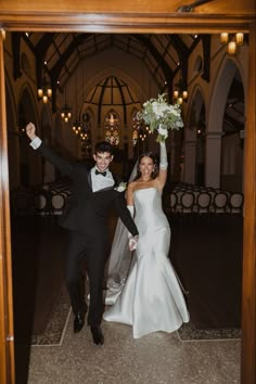 a bride and groom are walking down the aisle at their wedding reception in an old church