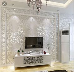 a living room with white wallpaper and chandelier