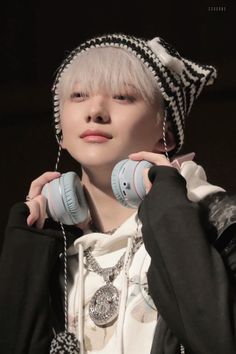 a person with white hair wearing headphones