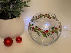 a glass bowl sitting on top of a table next to a christmas ornament