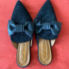 Black Suede Mules With Leather Bow. Size 39z Worn Twice. Elegant Black Flat Mules, Elegant Black Flat Heel Mules, Chic Black Flat Mules, Black Flat Mules For Party, Black Pointed Toe Party Flats, Black Slip-on Party Flats, Black Slip-on Flats For Party, Chic Black Closed Toe Flats, Chic Black Flats With Leather Sole