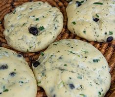 four biscuits with cheese and olives in a wicker basket