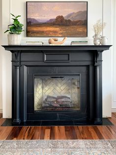 a fireplace with a painting above it and the words diy electric fireplace using an antique mantel