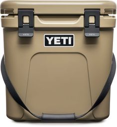 the yeti cooler is tan with black handles