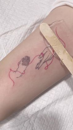 a woman's leg with a tattoo on it and a pair of scissors in front of her