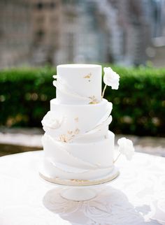 a white wedding cake sitting on top of a table